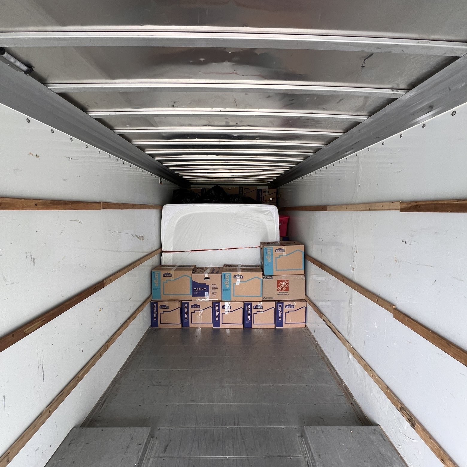 Boxes and mattress neatly stacked